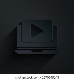Paper cut Online play video icon isolated on black background. Laptop and film strip with play sign. Paper art style. Vector Illustration