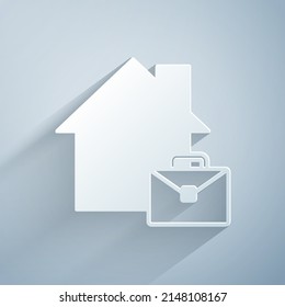 Paper cut Online working icon isolated on grey background. Freelancer man working on laptop at his house. Remote work. Distant job concept. Paper art style. Vector