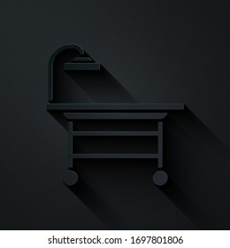 Paper cut Operating table icon isolated on black background. Paper art style. Vector Illustration