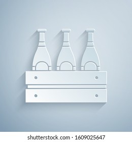 Paper cut Pack of beer bottles icon isolated on grey background. Wooden box and beer bottles. Case crate beer box sign. Paper art style. Vector Illustration