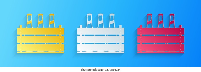 Paper cut Pack of beer bottles icon isolated on blue background. Wooden box and beer bottles. Case crate beer box sign. Paper art style. Vector.