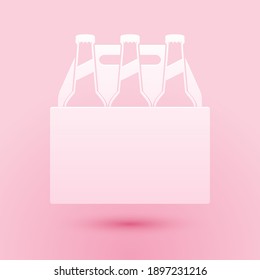 Paper cut Pack of beer bottles icon isolated on pink background. Case crate beer box sign. Paper art style. Vector.