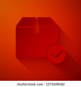 Paper cut Package box with check mark icon isolated on red background. Parcel box with checkmark. Approved delivery or successful package receipt. Paper art style. Vector Illustration