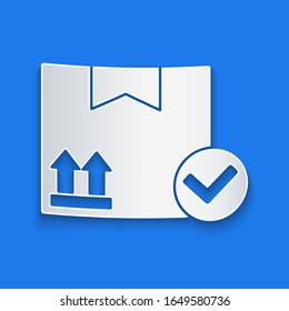 Paper cut Package box with check mark icon isolated on blue background. Parcel box. Approved delivery or successful package receipt. Paper art style. Vector Illustration