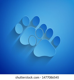Paper cut Paw print icon isolated on blue background. Dog or cat paw print. Animal track. Paper art style. Vector Illustration