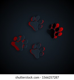 Paper cut Paw print icon isolated on black background. Dog or cat paw print. Animal track. Paper art style. Vector Illustration