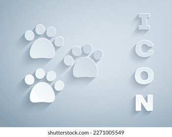 Paper cut Paw print icon isolated on grey background. Dog or cat paw print. Animal track. Paper art style. Vector