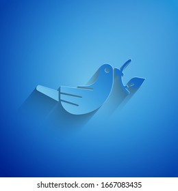 Paper cut Peace dove with olive branch icon isolated on blue background. Happy Easter. Paper art style. Vector Illustration
