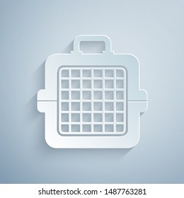 Paper cut Pet carry case icon isolated on grey background. Carrier for animals, dog and cat. Container for animals. Animal transport box. Paper art style. Vector Illustration