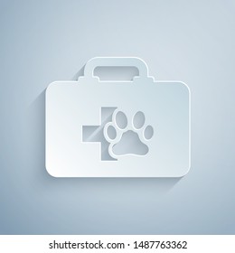 Paper cut Pet first aid kit icon isolated on grey background. Dog or cat paw print. Clinic box. Paper art style. Vector Illustration