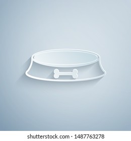Paper cut Pet food bowl for cat or dog icon isolated on grey background. Dog bone sign. Paper art style. Vector Illustration