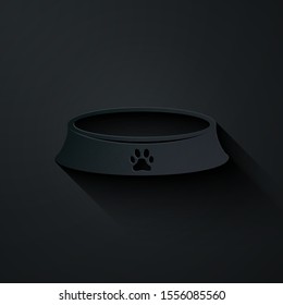 Paper cut Pet food bowl for cat or dog icon isolated on black background. Dog or cat paw print. Paper art style. Vector Illustration