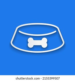 Paper cut Pet food bowl for cat or dog icon isolated on blue background. Dog or cat paw print. Paper art style. Vector