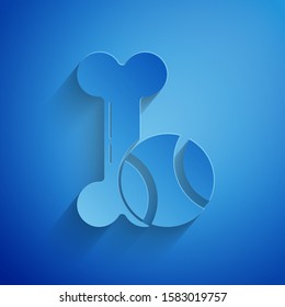 Paper cut Pet toys bone rubber and ball icon isolated on blue background. Paper art style. Vector Illustration