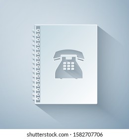 Paper cut Phone book icon isolated on grey background. Address book. Telephone directory. Paper art style. Vector Illustration