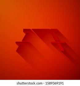 Paper cut Picnic table with benches on either side of the table icon isolated on red background. Paper art style. Vector Illustration