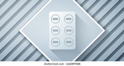 Paper cut Pills in blister pack icon isolated on grey background. Medical drug package for tablet, vitamin, antibiotic, aspirin. Paper art style. Vector Illustration