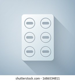 Paper cut Pills in blister pack icon isolated on grey background. Medical drug package for tablet, vitamin, antibiotic, aspirin. Paper art style. Vector Illustration