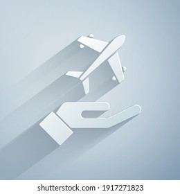 Paper cut Plane in hand icon isolated on grey background. Flying airplane. Airliner insurance. Security, safety, protection, protect concept. Paper art style. Vector