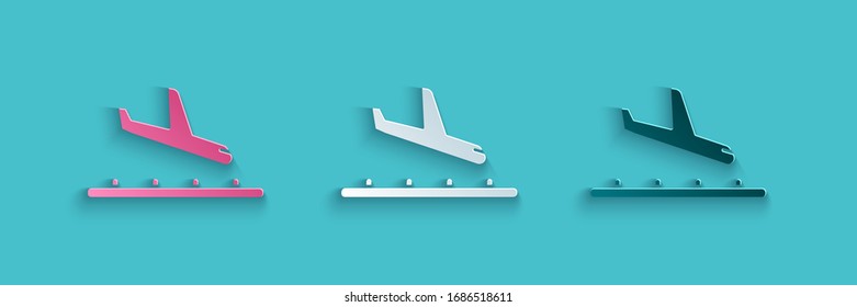 Paper cut Plane landing icon isolated on blue background. Airplane transport symbol. Paper art style. Vector Illustration