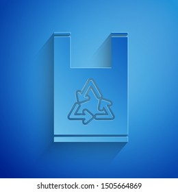 Paper cut Plastic bag with recycle icon isolated on blue background. Bag with recycling symbol. Paper art style. Vector Illustration