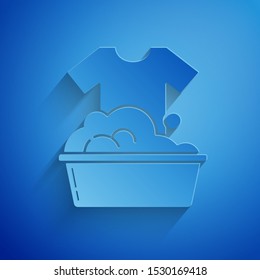 Paper cut Plastic basin with soap suds icon isolated on blue background. Bowl with water. Washing clothes, cleaning equipment. Paper art style. Vector Illustration