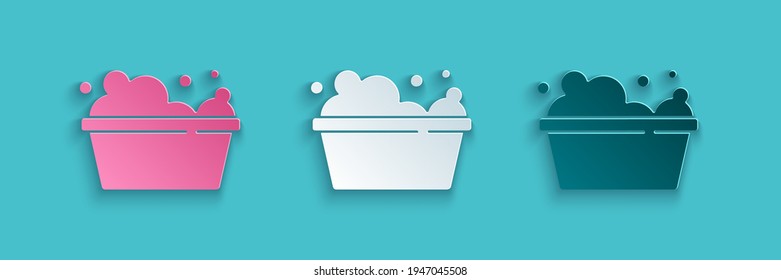 Paper cut Plastic basin with soap suds icon isolated on blue background. Bowl with water. Washing clothes, cleaning equipment. Paper art style. Vector