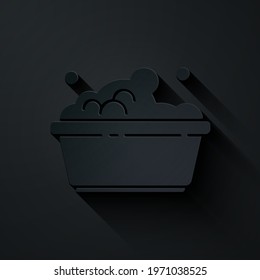 Paper cut Plastic basin with soap suds icon isolated on black background. Bowl with water. Washing clothes, cleaning equipment. Paper art style. Vector Illustration