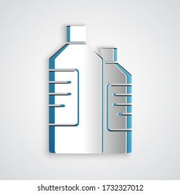 Paper cut Plastic bottles for laundry detergent, bleach, dishwashing liquid or another cleaning agent icon isolated on grey background. Paper art style. Vector Illustration