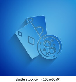 Paper cut Playing cards and glass of whiskey with ice cubes icon isolated on blue background. Casino gambling. Paper art style. Vector Illustration