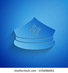 Paper cut Police cap with cockade icon isolated on blue background. Police hat sign. Paper art style. Vector Illustration