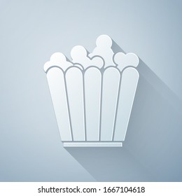 Paper cut Popcorn in cardboard box icon isolated on grey background. Popcorn bucket box. Paper art style. Vector Illustration