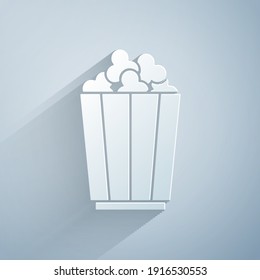 Paper cut Popcorn in cardboard box icon isolated on grey background. Popcorn bucket box. Paper art style. Vector