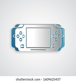 Paper cut Portable video game console icon isolated on grey background. Gamepad sign. Gaming concept. Paper art style. Vector Illustration