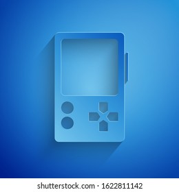 Paper cut Portable video game console icon isolated on blue background. Gamepad sign. Gaming concept. Paper art style. Vector Illustration