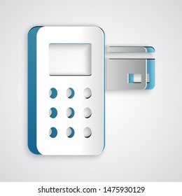 Paper cut Pos terminal with inserted credit card icon isolated on grey background. Payment terminal transaction. Paper art style. Vector Illustration