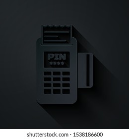 Paper cut POS terminal with inserted credit card and printed reciept icon isolated on black background. NFC payment concept. Paper art style. Vector Illustration