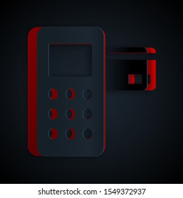 Paper cut Pos terminal with inserted credit card icon isolated on black background. Payment terminal transaction. Paper art style. Vector Illustration