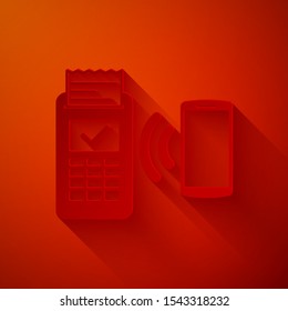 Paper cut POS terminal with printed reciept and confirms the payment by smartphone icon isolated on red background. NFC payment concept. Paper art style. Vector Illustration