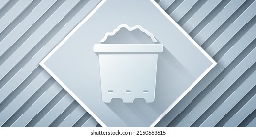 Paper cut Pot with soil icon isolated on grey background. Paper art style. Vector