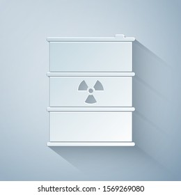 Paper cut Radioactive waste in barrel icon isolated on grey background. Radioactive garbage emissions, environmental pollution, danger of ecological disaster. Paper art style. Vector Illustration