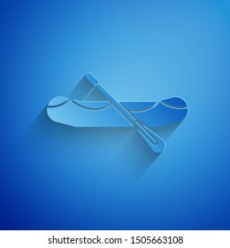Paper cut Rafting boat icon isolated on blue background. Inflatable boat with paddles. Water sports, extreme sports, holiday, vacation. Paper art style. Vector Illustration