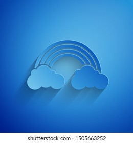 Paper cut Rainbow with clouds icon isolated on blue background. Paper art style. Vector Illustration