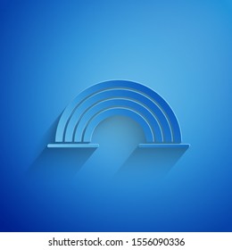Paper cut Rainbow with clouds icon isolated on blue background. Paper art style. Vector Illustration