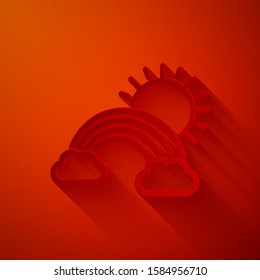 Paper cut Rainbow with clouds and sun icon isolated on red background. Paper art style. Vector Illustration