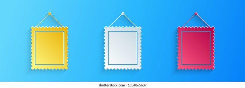 Paper cut Rectangular picture frame hanging on the wall icon isolated on blue background. Paper art style. Vector.