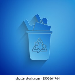 Paper cut Recycle bin with recycle symbol icon isolated on blue background. Trash can icon. Garbage bin sign. Recycle basket sign. Paper art style. Vector Illustration
