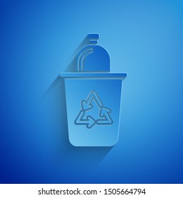 Paper cut Recycle bin with recycle symbol icon isolated on blue background. Trash can icon. Garbage bin sign. Recycle basket sign. Paper art style. Vector Illustration