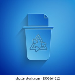 Paper cut Recycle bin with recycle symbol icon isolated on blue background. Trash can icon. Garbage bin sign. Recycle basket sign. Paper art style. Vector Illustration