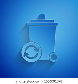 Paper cut Recycle bin with recycle symbol icon isolated on blue background. Trash can icon. Garbage bin sign. Recycle basket sign. Paper art style. Vector Illustration